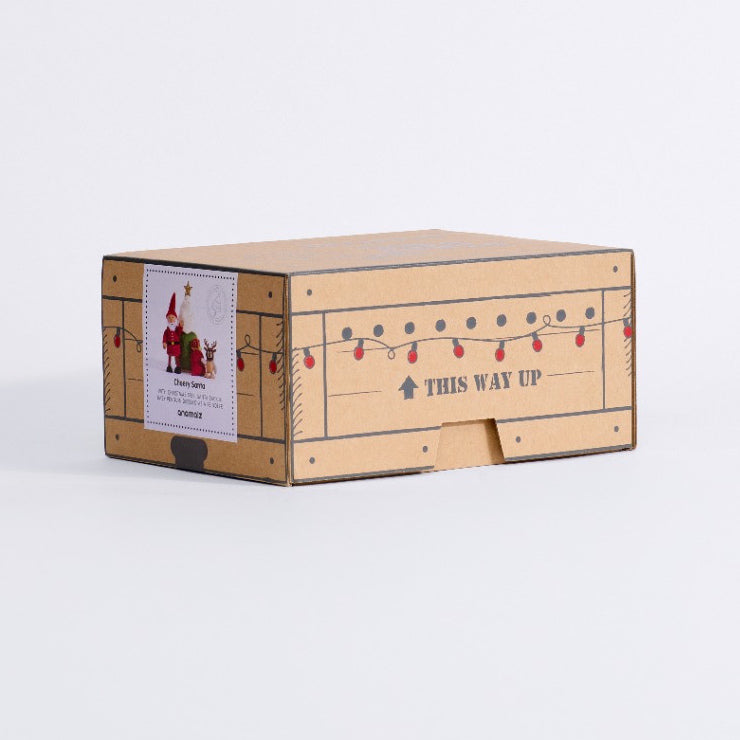 Three-quarter view of the Cheery Santa gift box showing its illustrated side and product label